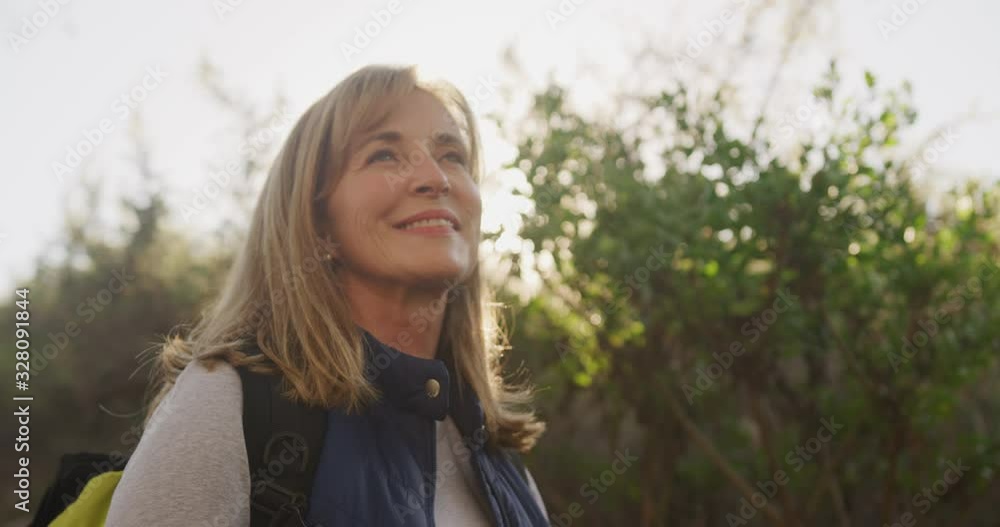 Active senior woman smiling in forest
