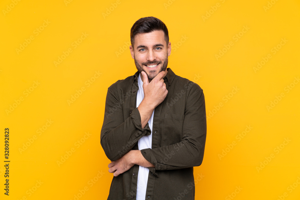 Man over isolated yellow background laughing Man over isolated yellow background laughing