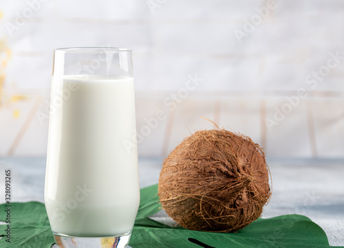 Fresh coconut milk in glass, vegan healthy drink