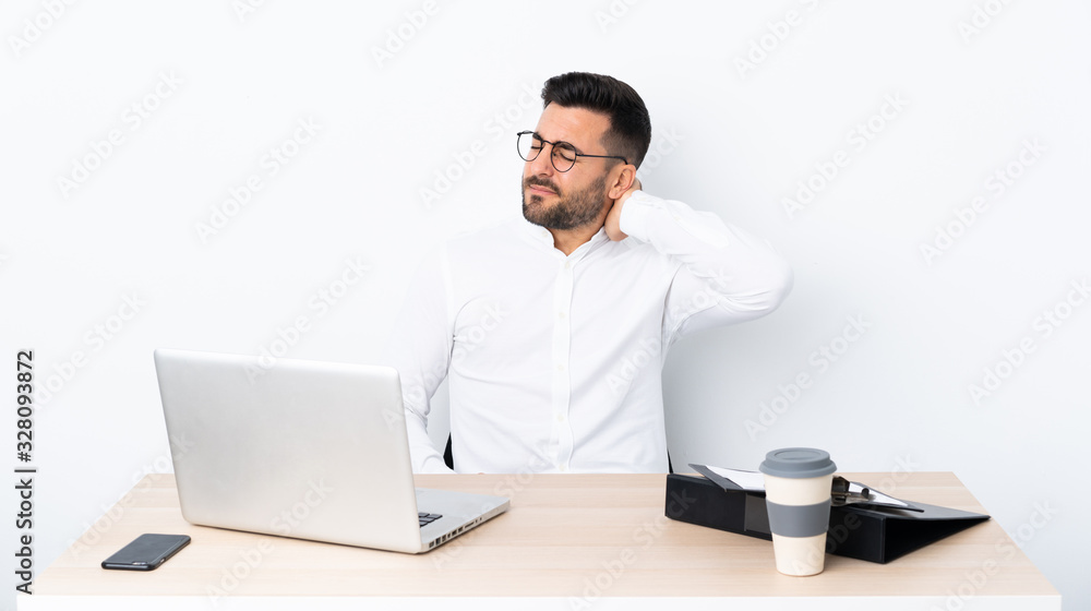 Young businessman in a workplace with neckache Young businessman in a workplace with neckache