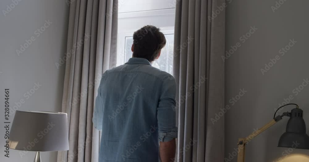 Young man looking through the window Young man looking through the window