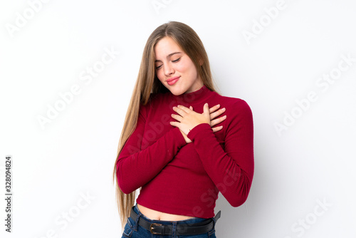 Teenager blonde girl over isolated white background having a pain in the heart