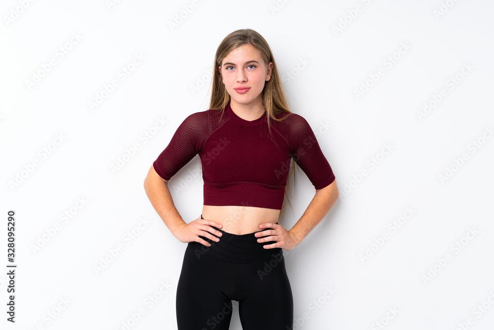 Sport teenager girl over isolated white background posing with arms at hip Sport teenager girl over isolated white background posing with arms at hip