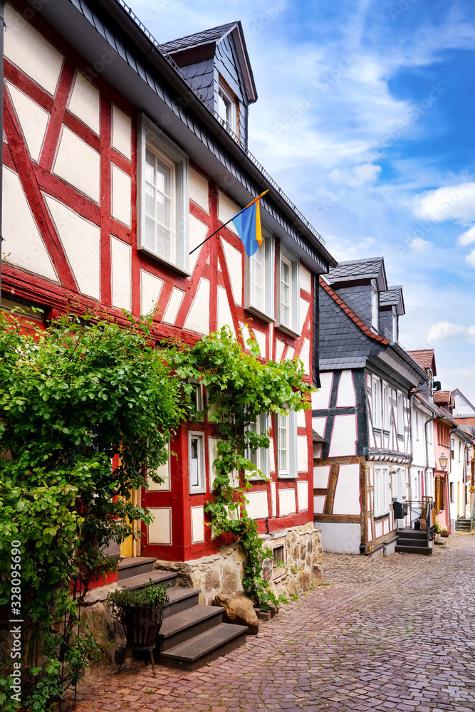 Street of Idstein town in the Taunus area with traditional half timbered houses on a beautiful summer-day.