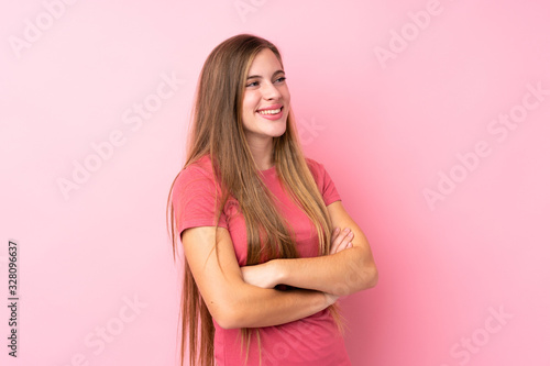 Teenager blonde girl over isolated pink background looking to the side