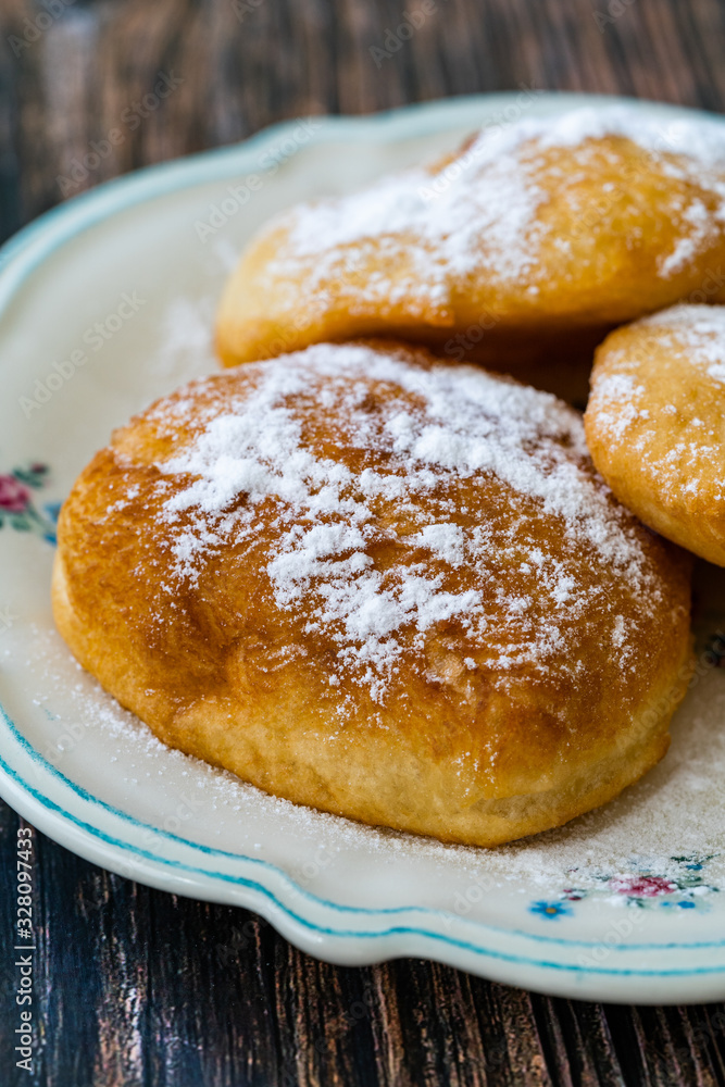 Mandazi is a slightly sweet East African Street Food; spicy, airy yeast doughnut dough made with coconut milk, flavored with cardamom and grated fresh coconut. Mandazi is a slightly sweet East African Street Food; spicy, airy yeast doughnut dough made with coconut milk, flavored with cardamom and grated fresh coconut.