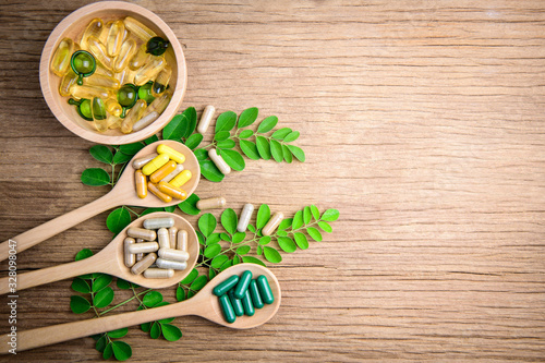 Fototapeta Naklejka Na Ścianę i Meble -  Herbal medicine, vitamin and supplements nutrition for good healthy on wooden background, medicine and drug concept