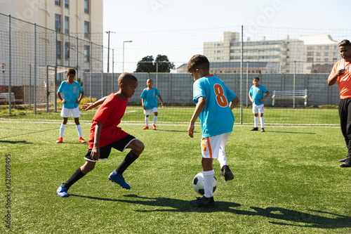 Children training to play soccer on the field photo