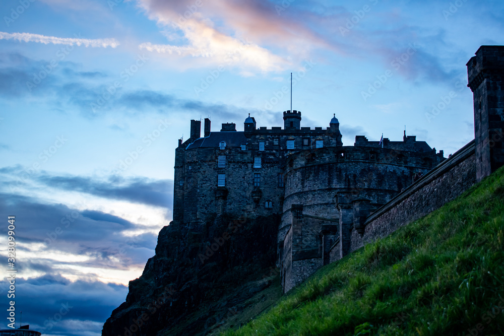 castle in edimburgh city, scotland on the rocks with a blue sky at sunset castle in edimburgh city, scotland on the rocks with a blue sky at sunset