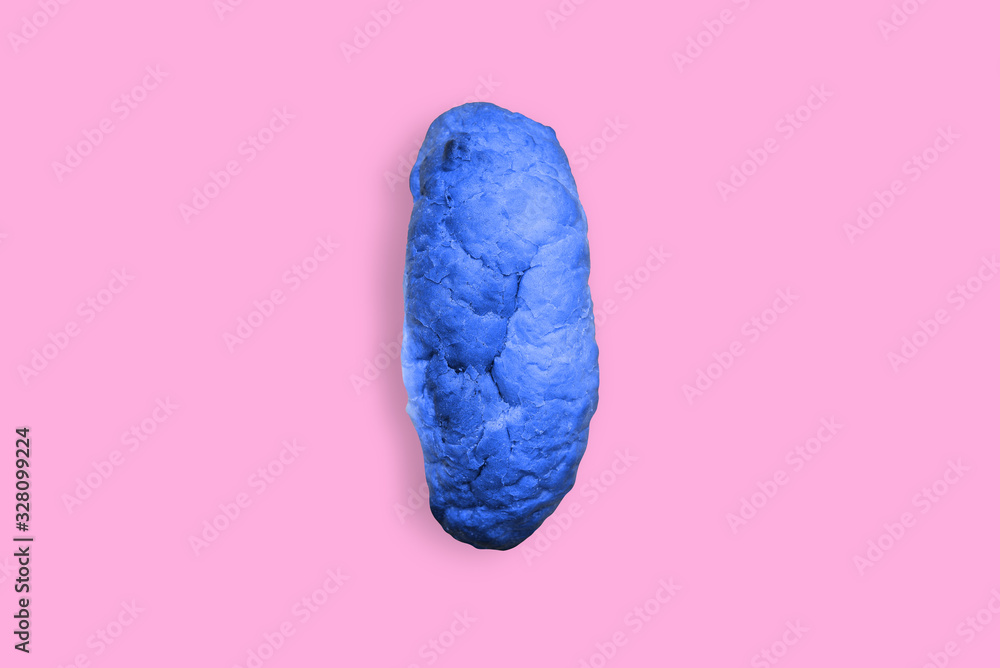 Naklejka premium Blue bread on a pink background. Contemporary art, pop art.