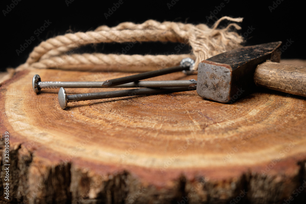Nails, hammer and rope lie on a wooden board. Papa's Day, Papa's Holiday. Construction and repair Nails, hammer and rope lie on a wooden board. Papa's Day, Papa's Holiday. Construction and repair