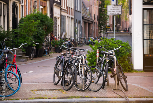 Amsterdam city in Netherlands with bycicles beside a canal