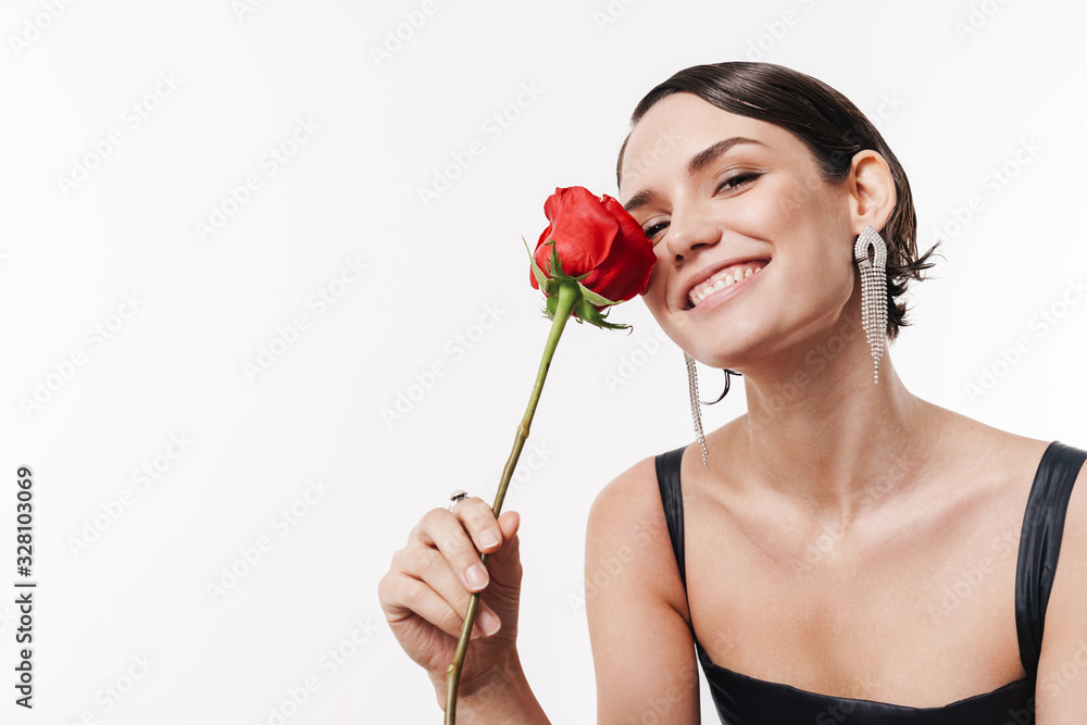 Image of charming young pretty woman smiling and holding flower