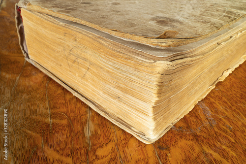 Aging book rests upon wooden table