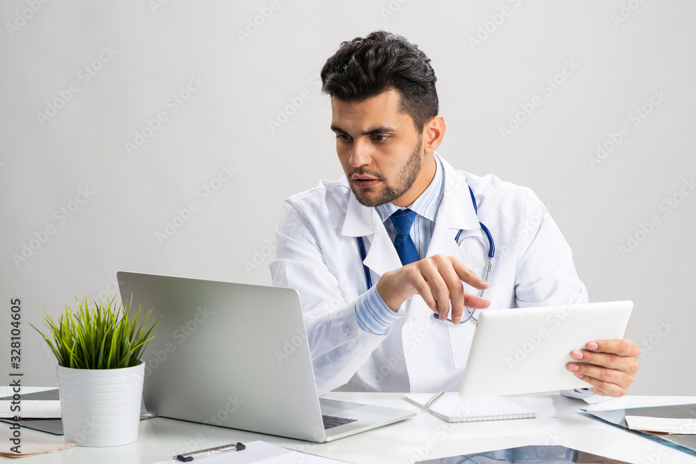 Young arab internist working with tablet computer Young arab internist working with tablet computer