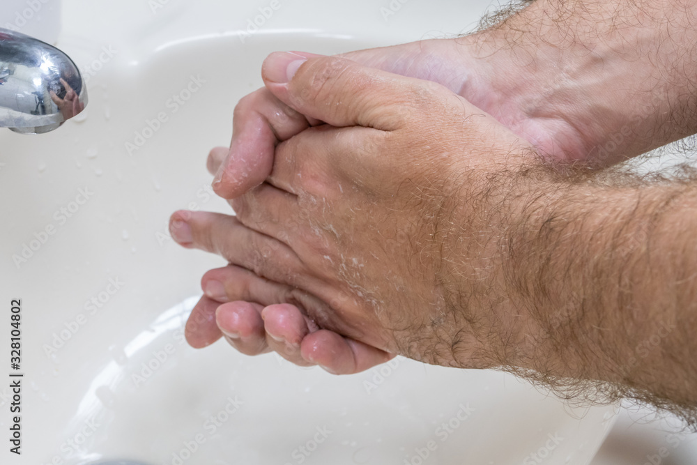 Fototapeta premium Man washing hands in basin close-up