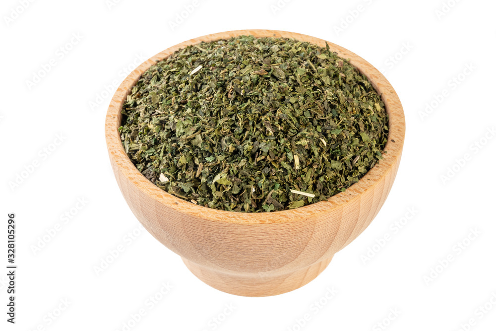 dried nettle herb or in latin Utricae folium in wooden bowl isolated on white background. medicinal healing herbs. herbal medicine. alternative medicine dried nettle herb or in latin Utricae folium in wooden bowl isolated on white background. medicinal healing herbs. herbal medicine. alternative medicine