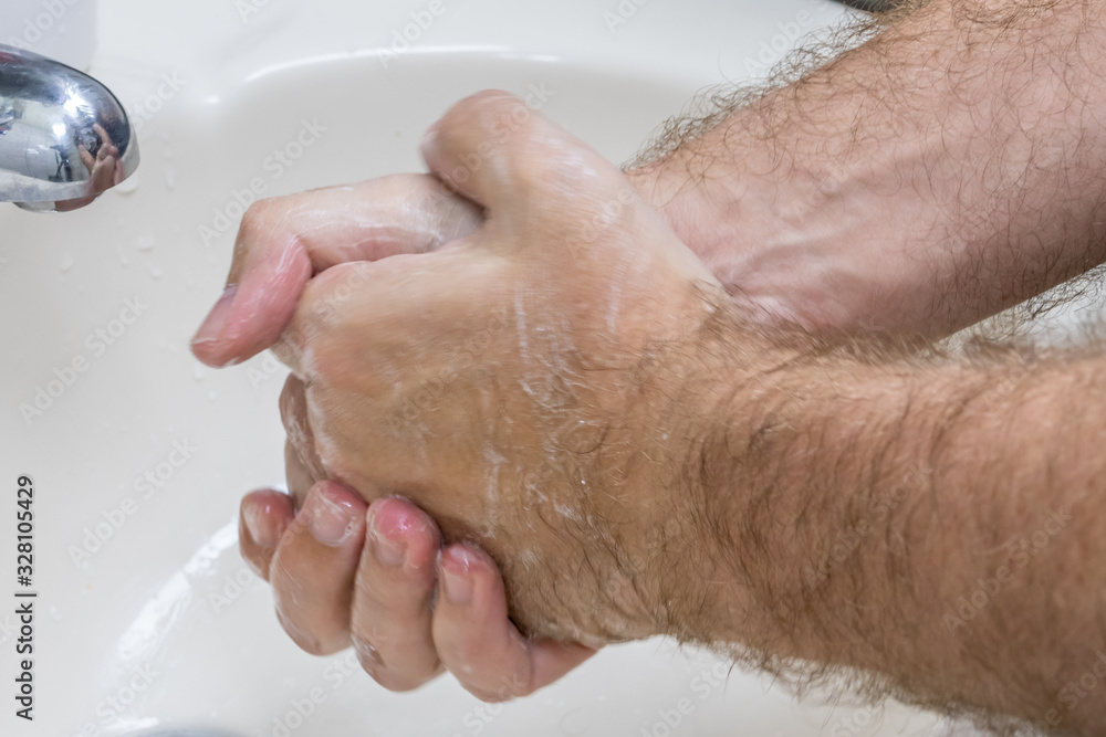 Fototapeta premium Man washing hands in basin close-up