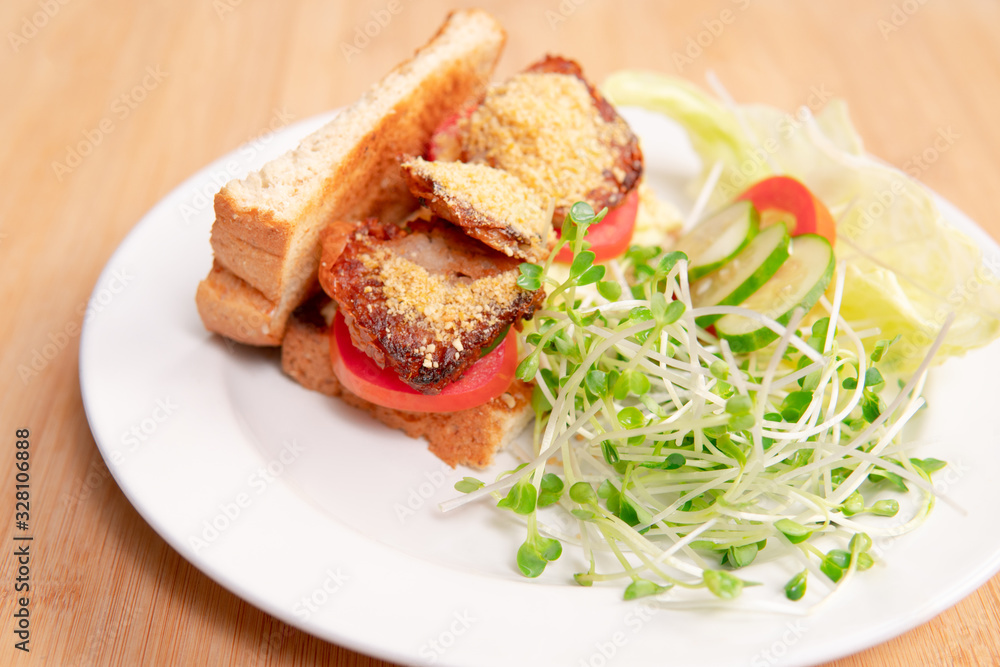 Vegan sandwich for breakfast, healthy & delicious food for plant based, vegan and vegetarian diet. Ingredients are toasted bread, vegan cheese, fried tofu, tomato, iceberg lettuce and kaiware sprouts. Vegan sandwich for breakfast, healthy & delicious food for plant based, vegan and vegetarian diet. Ingredients are toasted bread, vegan cheese, fried tofu, tomato, iceberg lettuce and kaiware sprouts.