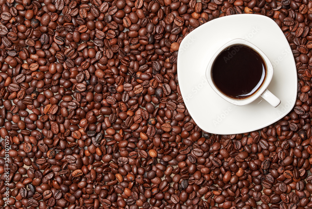 Cup of espresso coffee on a background of coffee beans. View from above. ?opy space Cup of espresso coffee on a background of coffee beans. View from above. ?opy space