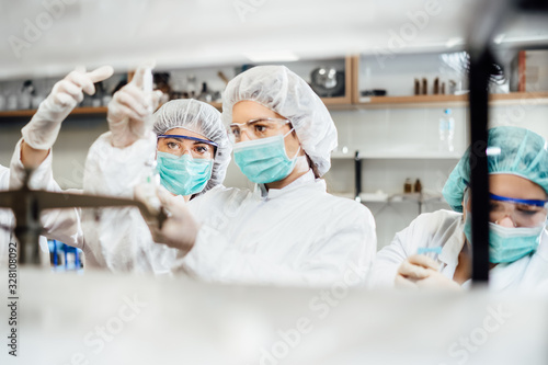 Team of pharmacist working on drug discovery.Development of new vaccine.Sterile cleanroom.Antivirus antidote immunization concept.Lab pre-clinic experiment.Disease biochemical analyisis.Diagnostics