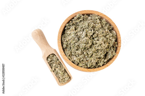 dried artichoke leaves or in latin Cynarae folium in wooden bowl and scoop isolated on white background. medicinal healing herbs. herbal medicine. alternative medicine