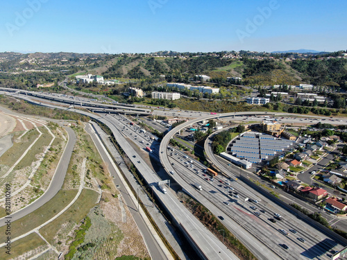 Aerial view of highway with traffic surrounded by houses in Diamond Bar City. Intersection city transport road with vehicle movement. Eastern Los Angeles, California, USA.