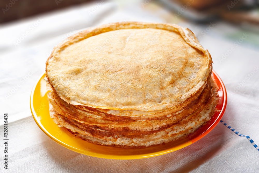 A stack of pancakes. Thin pancakes on a plate. Traditional food.