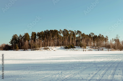 Russia, Moscow region, Grebnevo 08 February, 2020: Ice skaters. Barsky pond Rink. Winter sunny day photo