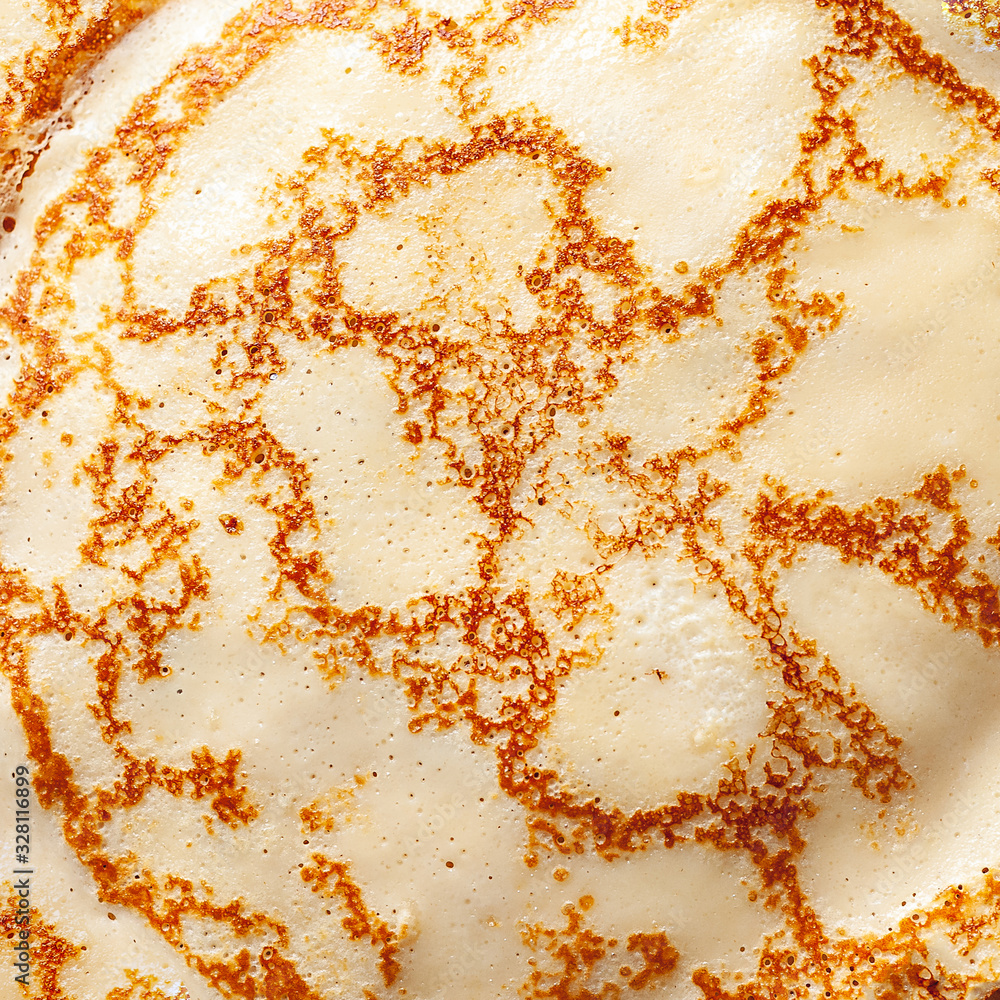 Pancake texture. Close-up of thin hot pancakes in a plate. Traditional rustic food. Pancake texture. Close-up of thin hot pancakes in a plate. Traditional rustic food.