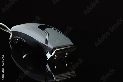 black hair barber clippers, haircut on black background
