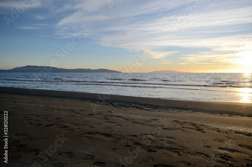 sunset on beach of Mediterranean sea  in Tuscany  Italy 