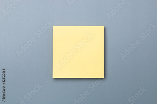 yellow sticky note with dramatic shade on grey background to add text copy space