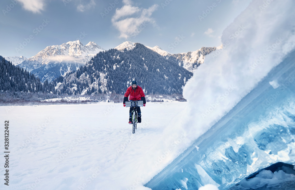 Man ride bicycle at frozen lake