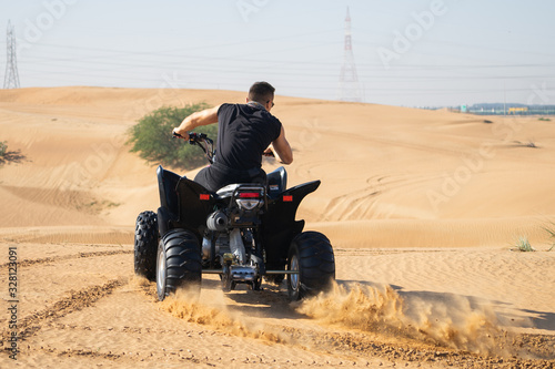 Muscular Man Riding Atv In the Desert