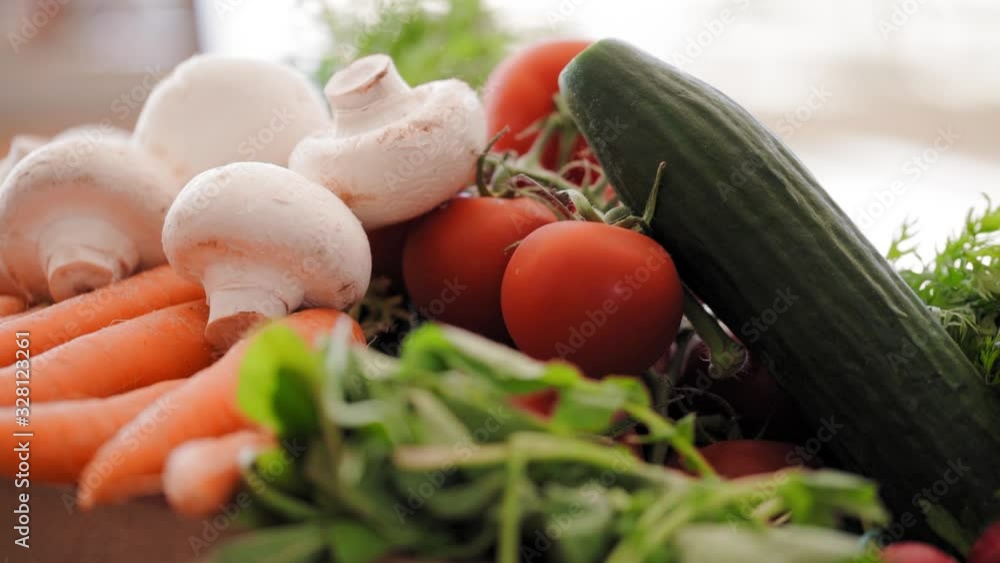 Colorful closeup of various vegetables such as tomatoes, cucumbers, mushrooms and carrots Colorful closeup of various vegetables such as tomatoes, cucumbers, mushrooms and carrots