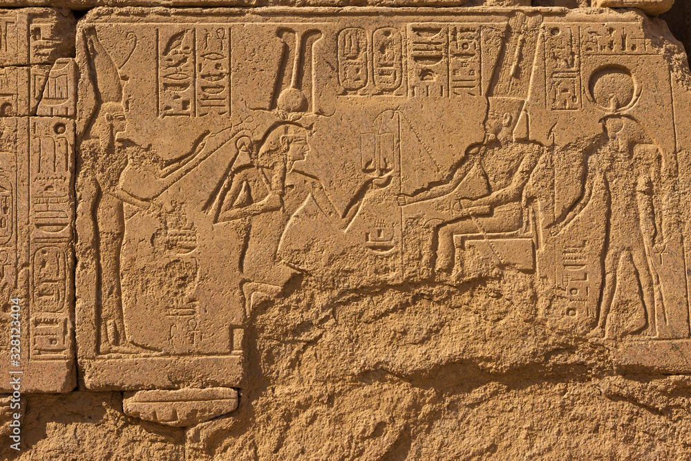 Karnak Temple, Colossal sculptures of ancient Egypt in the Nile Valley in Luxor, Embossed hieroglyphs on the wall. Karnak Temple, Colossal sculptures of ancient Egypt in the Nile Valley in Luxor, Embossed hieroglyphs on the wall.