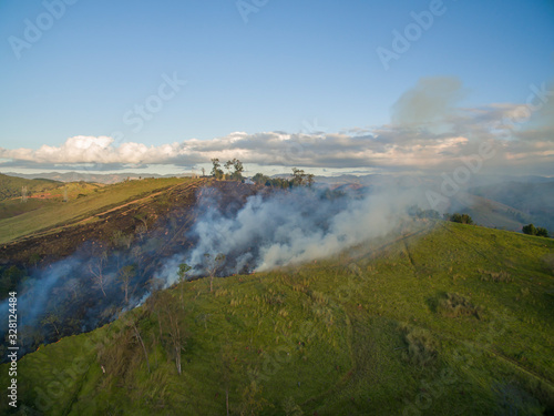 Grassland fire. Aerial view smoke of wildfire. Fire in the bush of Brazil.  © Ranimiro