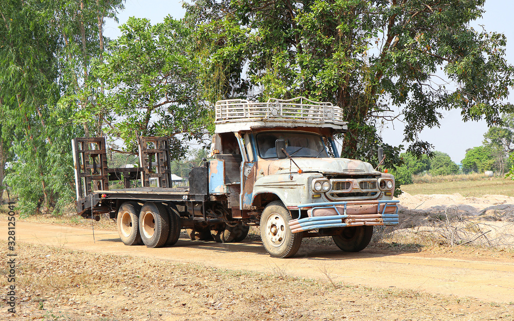 AMNATCHAROEN, THAILAND - FEB 27,2020 An old truck driving on a country road in Thailand., February 27th 2020.