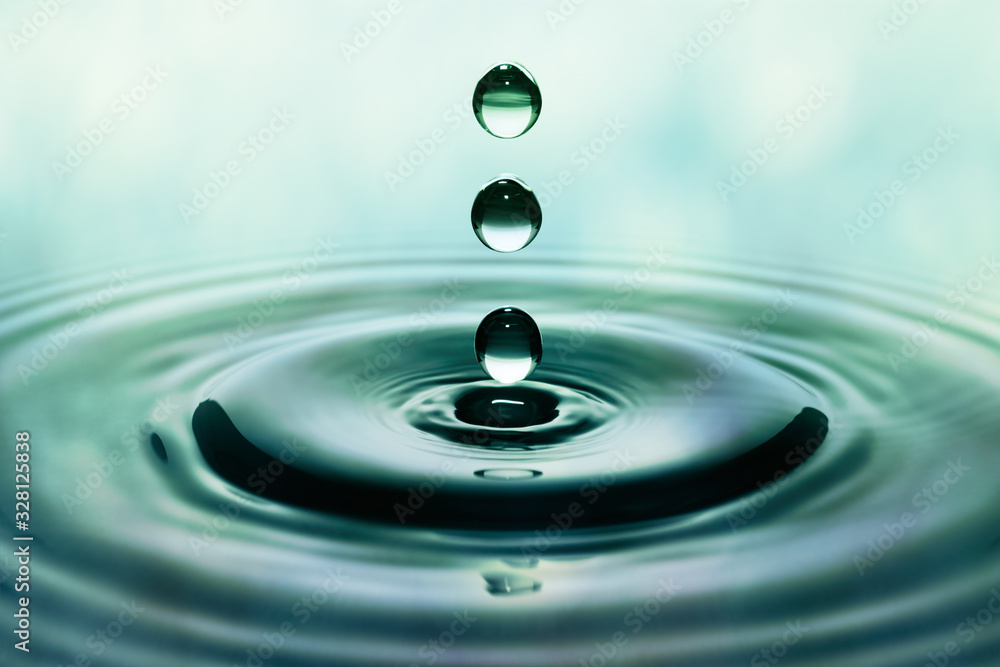Drops of rain falling on smooth water surface Drops of rain falling on smooth water surface