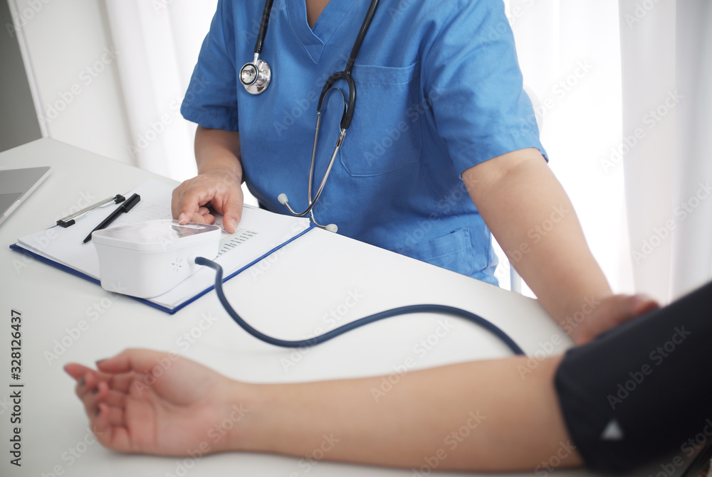 Female medicine doctor working on table with consulting patient Female medicine doctor working on table with consulting patient
