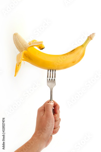 Banana on a fork in his hand