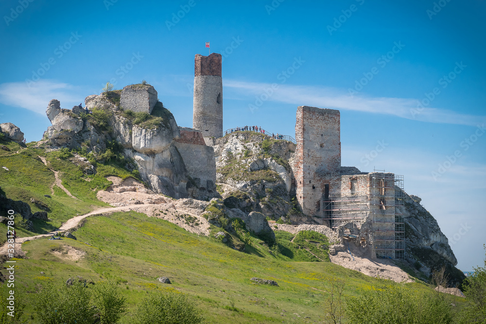 View on the ruins of ancient medieval castle in Europe on the stone rocks in the forest  in mountains