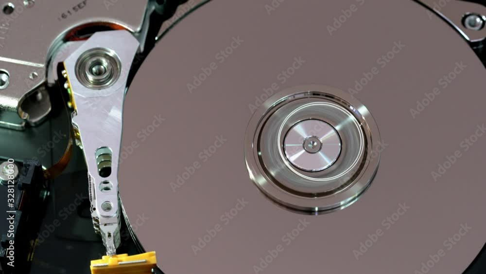 top view on an Internals of SATA hard disk drive working, Operating head of computer hard disk drive or HDD top view on an Internals of SATA hard disk drive working, Operating head of computer hard disk drive or HDD