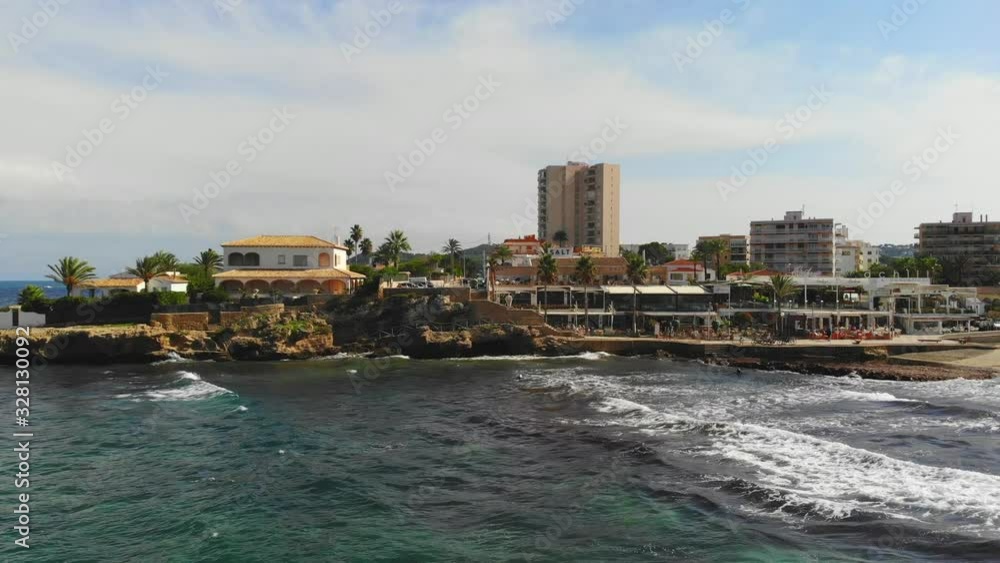 Drone flight over Arenal beach towards the promenade in the Spanish holiday town of Javea, Costa Blanca on a sunny day Drone flight over Arenal beach towards the promenade in the Spanish holiday town of Javea, Costa Blanca on a sunny day
