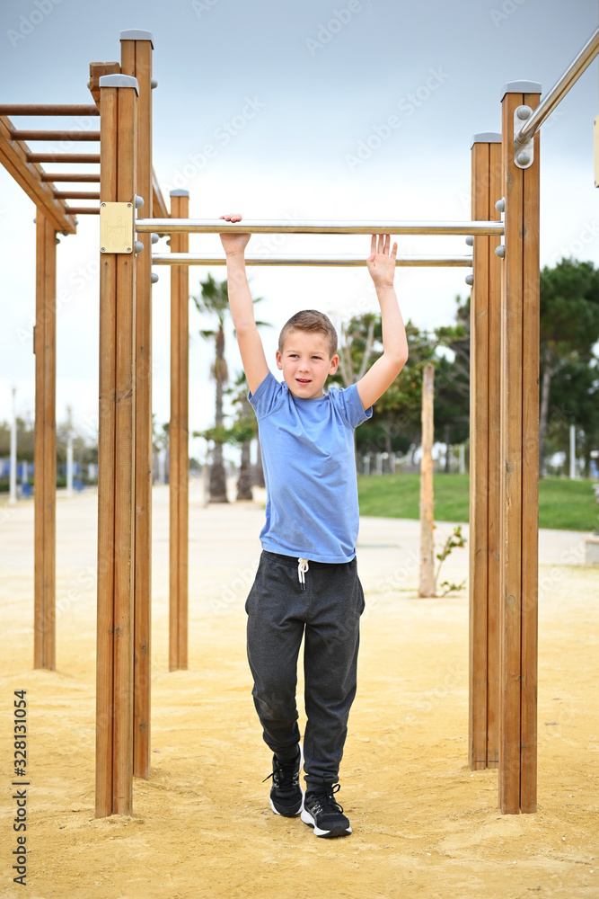 Fototapeta premium teenager boy 10 years old Asian appearance teenager doing sports in the afternoon on the beach