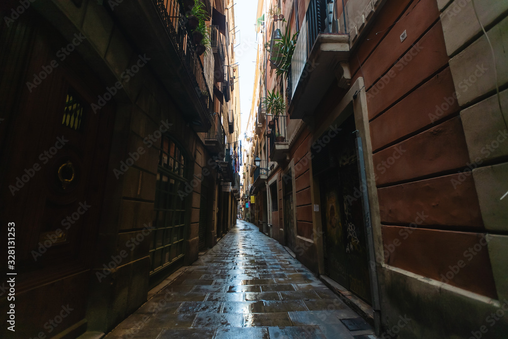 View of narrow wet alleyway in Gothic quarter, Barcelona, Spain View of narrow wet alleyway in Gothic quarter, Barcelona, Spain