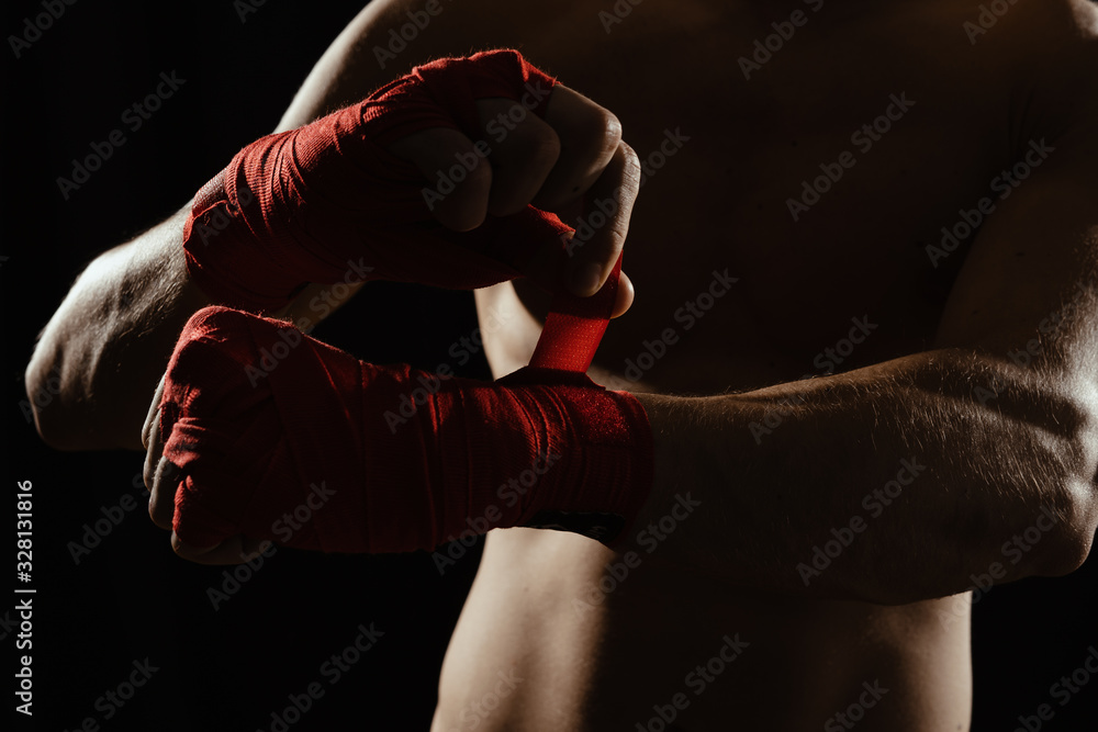 Close up boxer bandaging hands