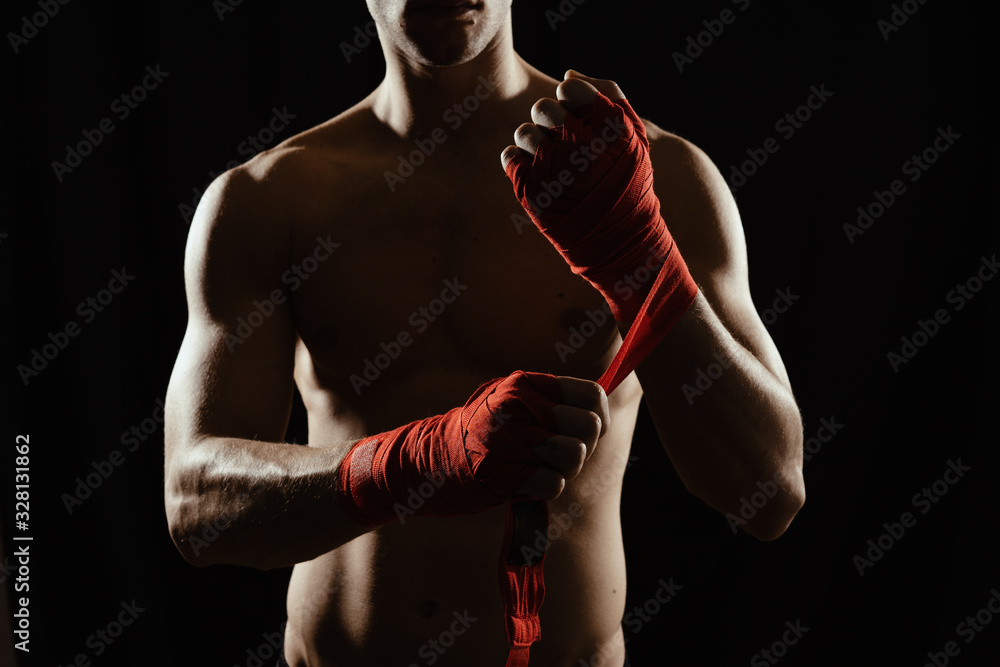 Fototapeta premium Close up boxer bandaging hands