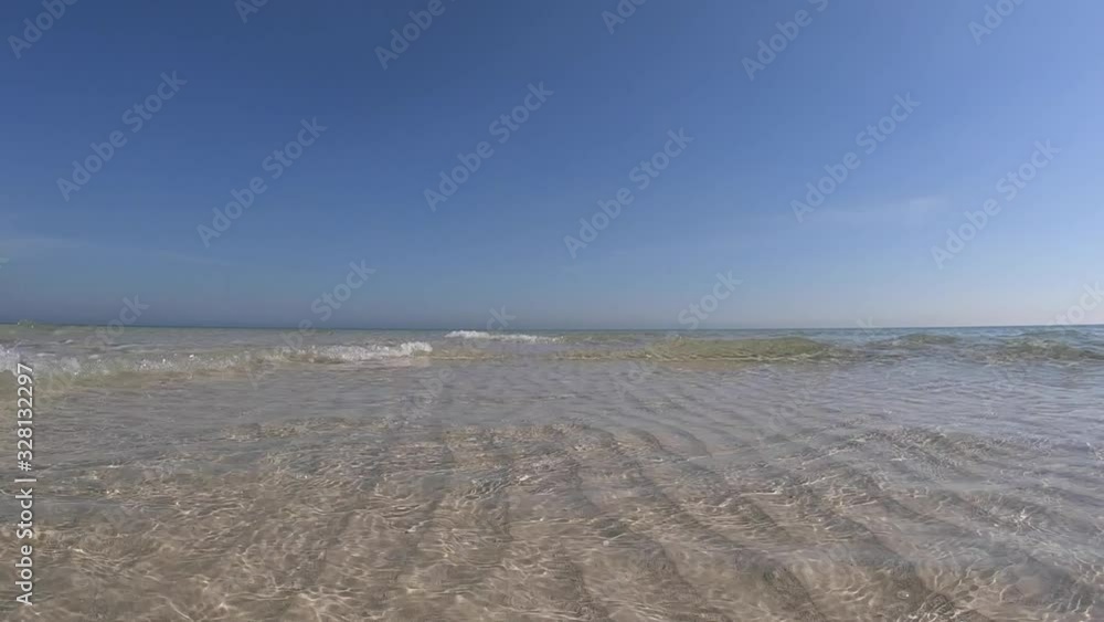 Slow-motion of Crystal clear shallow water and white sand with blue sky Slow-motion of Crystal clear shallow water and white sand with blue sky